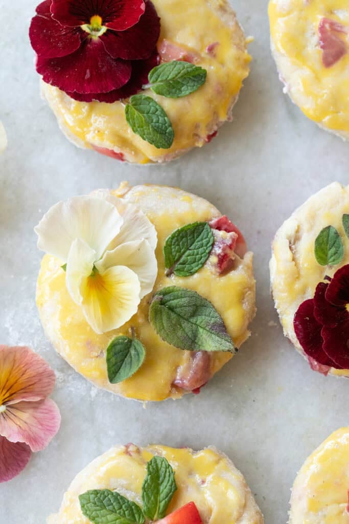 Strawberry scone with edible flowers and egg wash. 