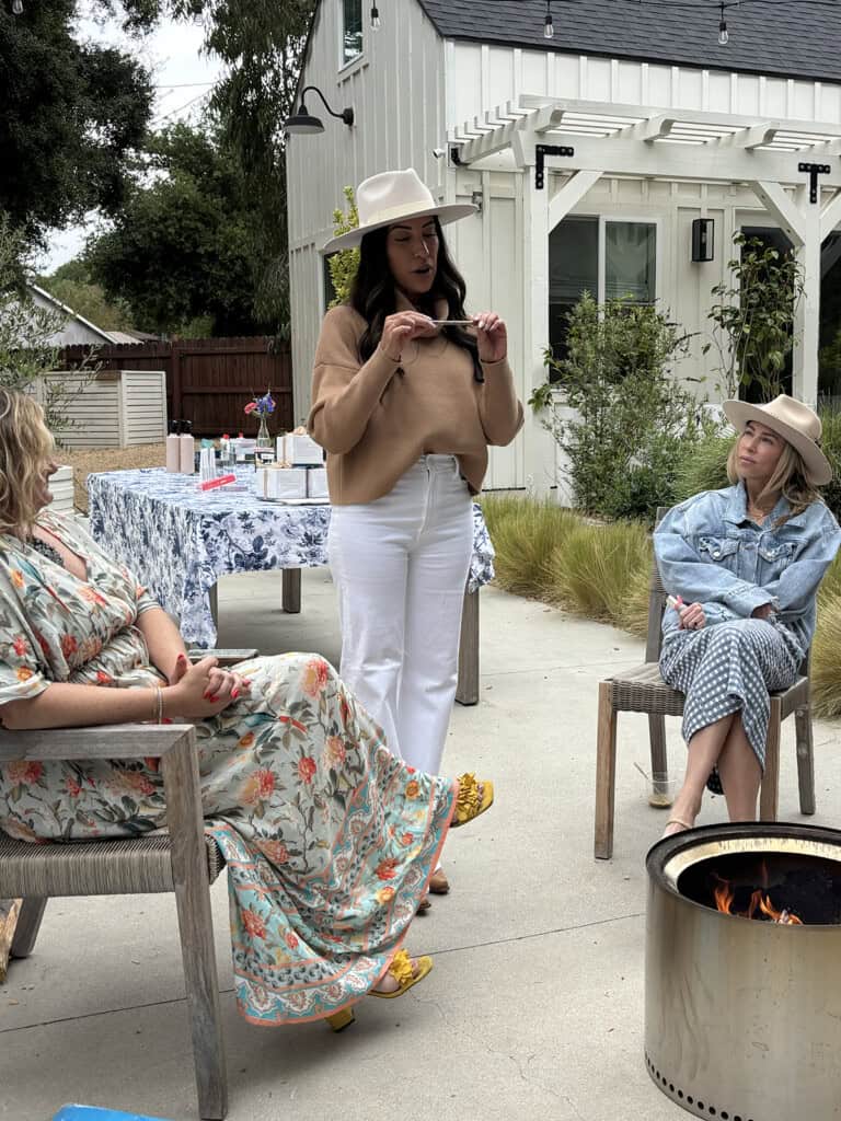 Woman holding up her favorite item and sharing why she loves it at a Favorite Things Party