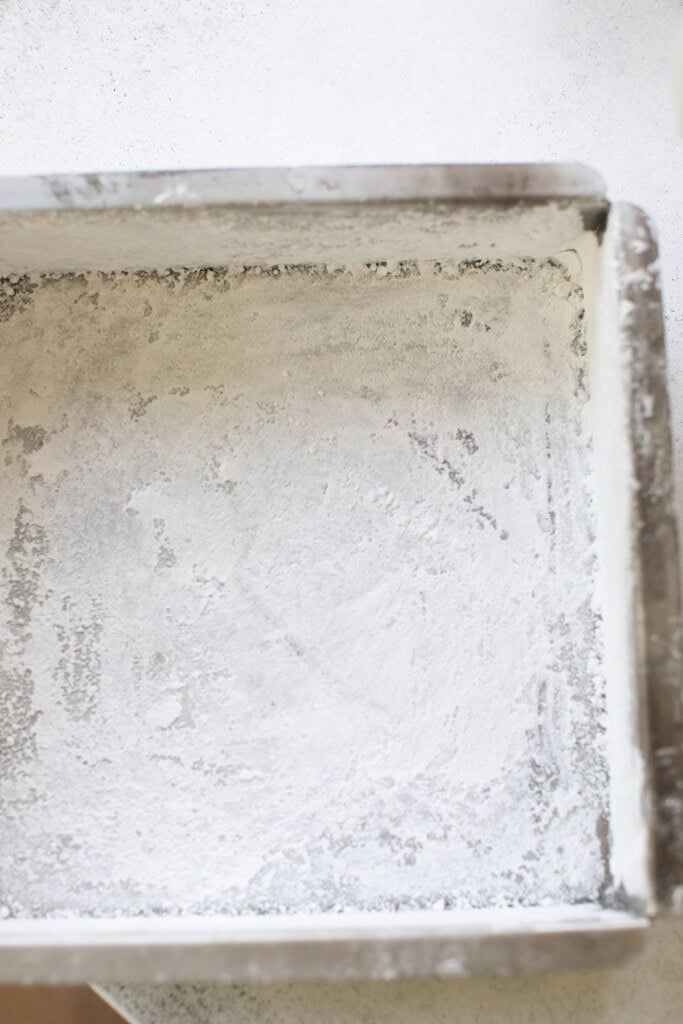 Prepping an 8x8 plan with powdered sugar to make marshmallows.