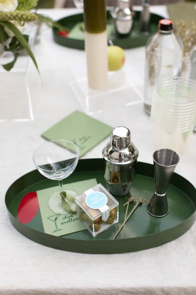 Dirty martini station with cocktail shaker, jigger, napkins.
