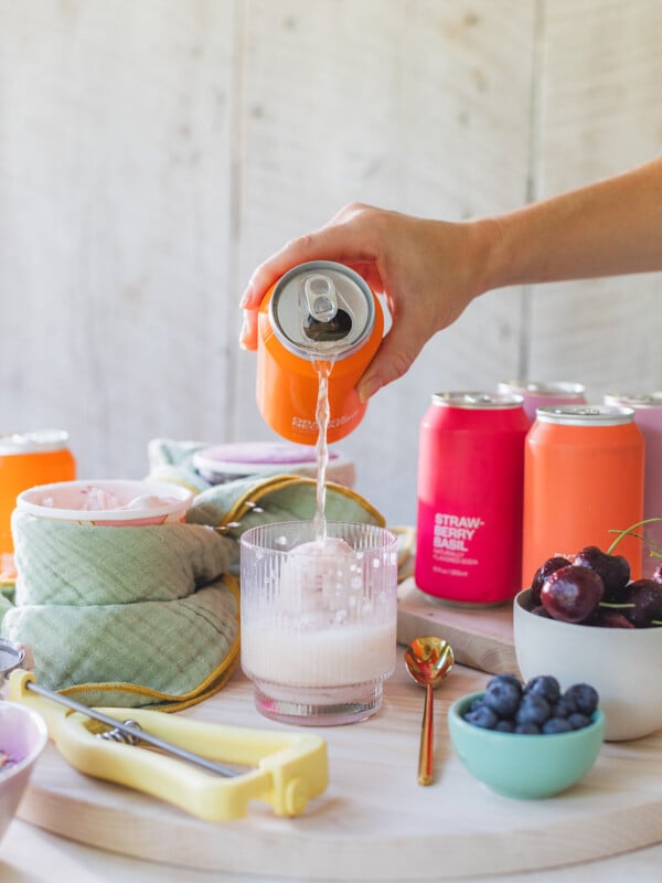 Pouring soda over ice cream in cups.