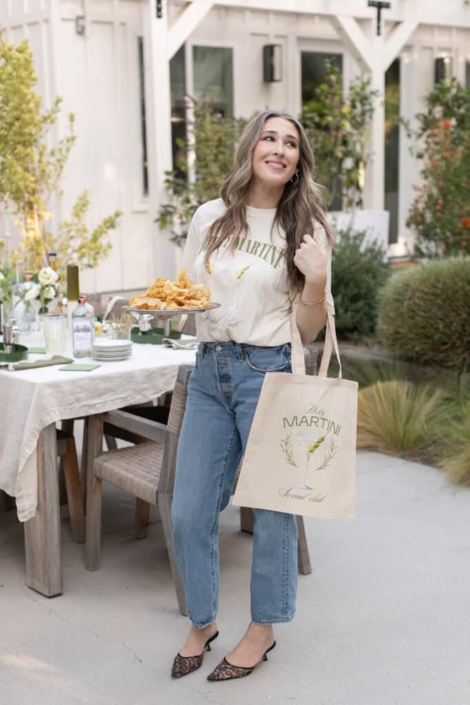 Eden Passante holding a martini social tote bag.