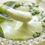 Dipping a pepper into green goddess dip.