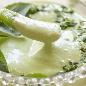 Dipping a pepper into green goddess dip.