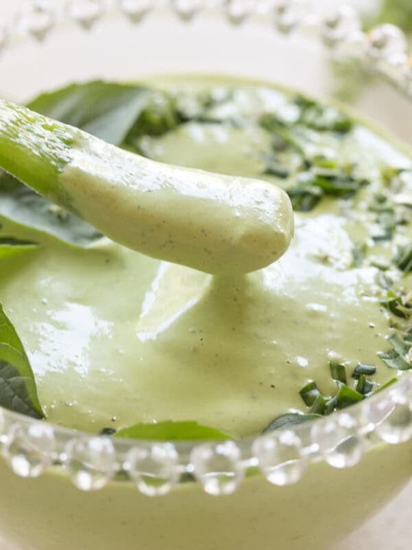 Dipping a pepper into green goddess dip.