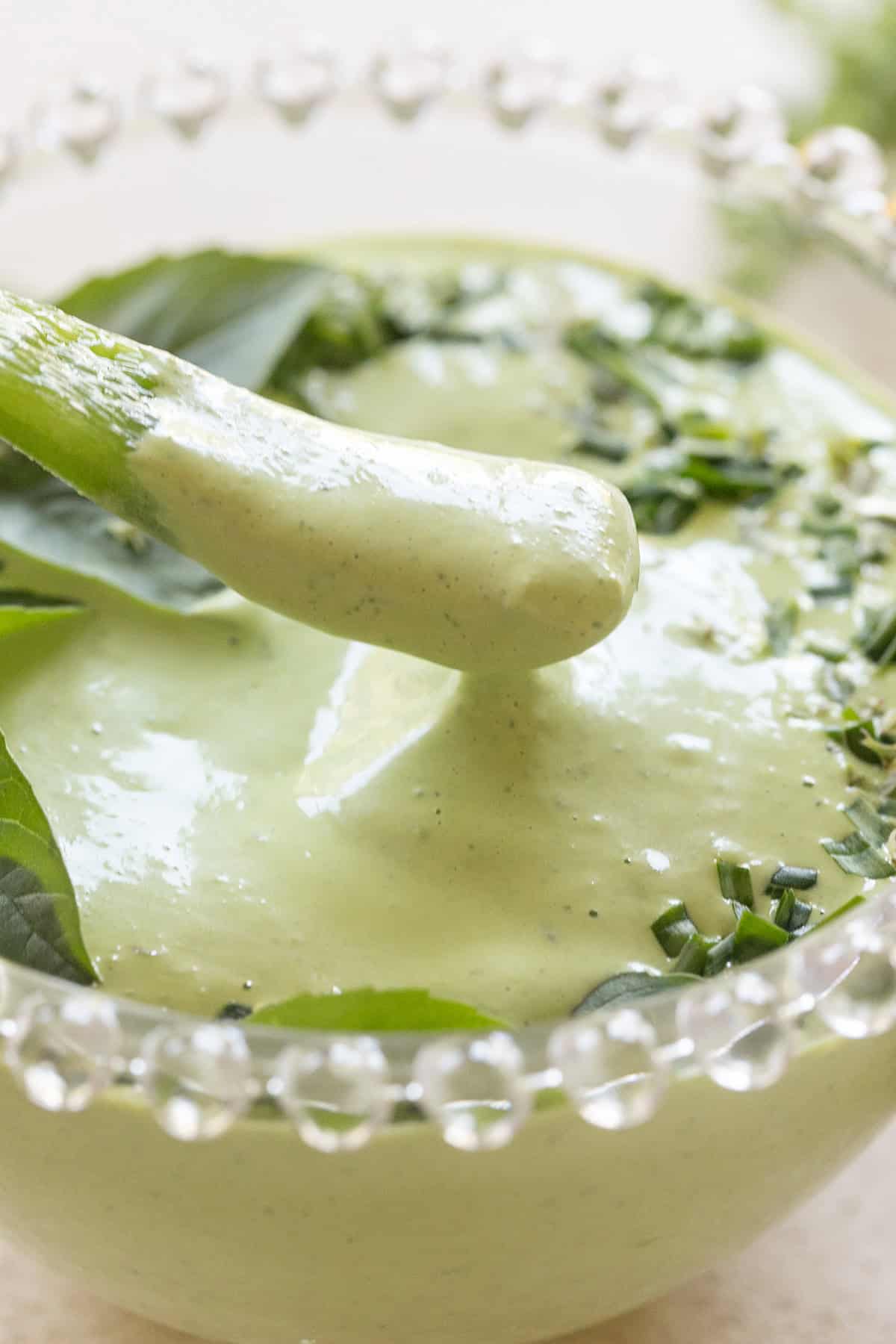 Dipping a pepper into green goddess dip.