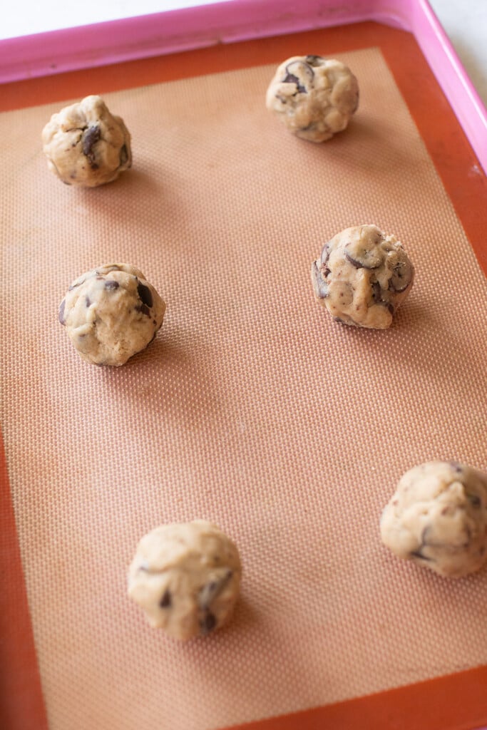 Brown butter cookie balls on a silpat.