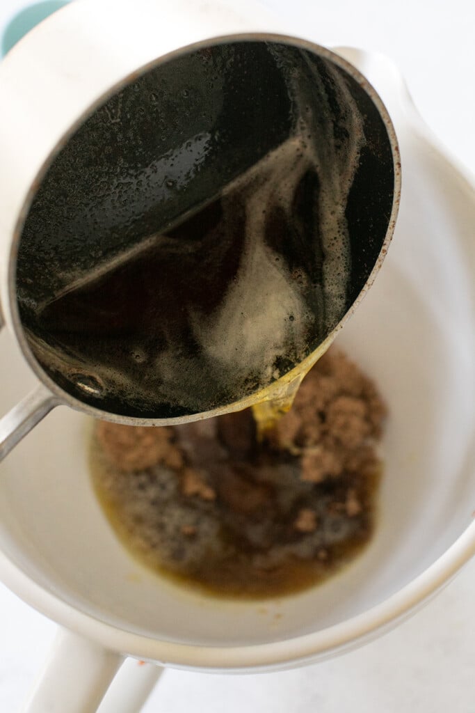 Brown butter going into a mixer with sugar.