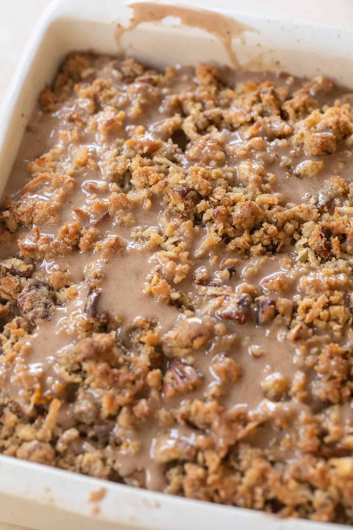 Overhead view of pumpkin crumb cake with cinnamon, nutmeg, and cardamom glaze.
