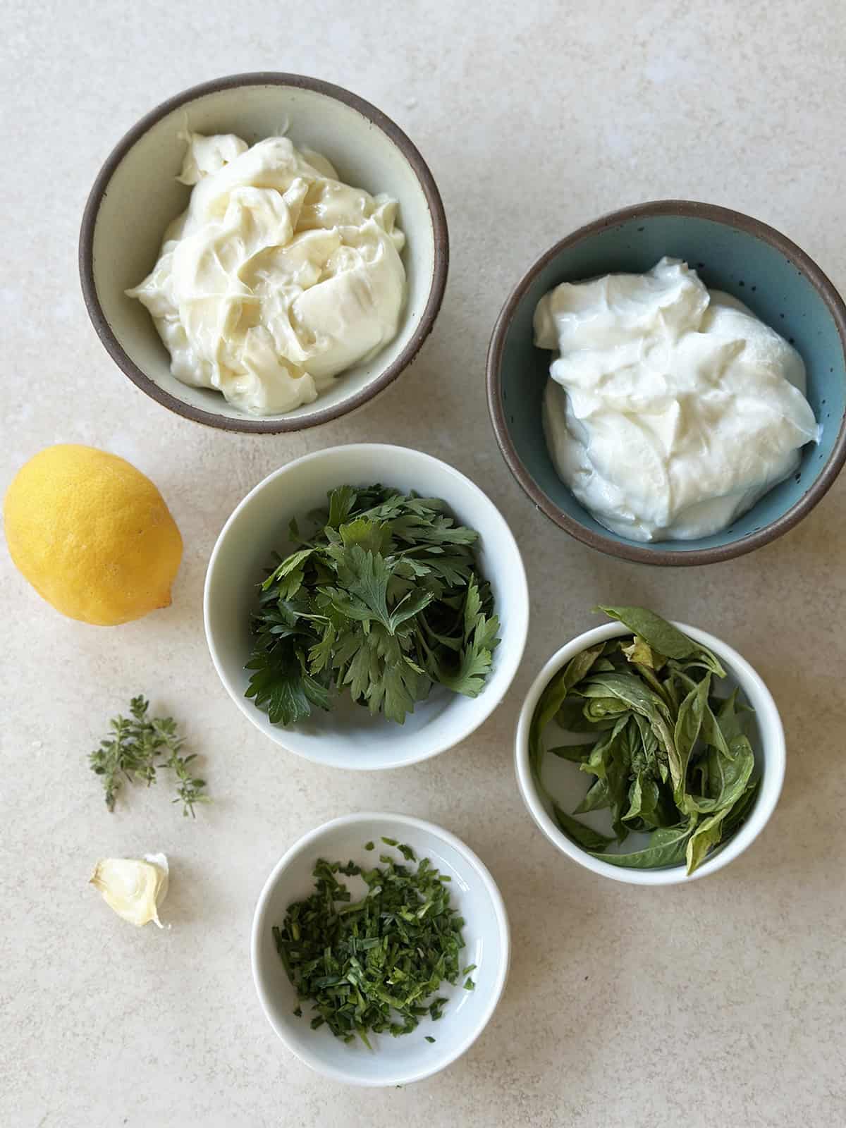 Ingredients in bowls to make green goddess dip.
