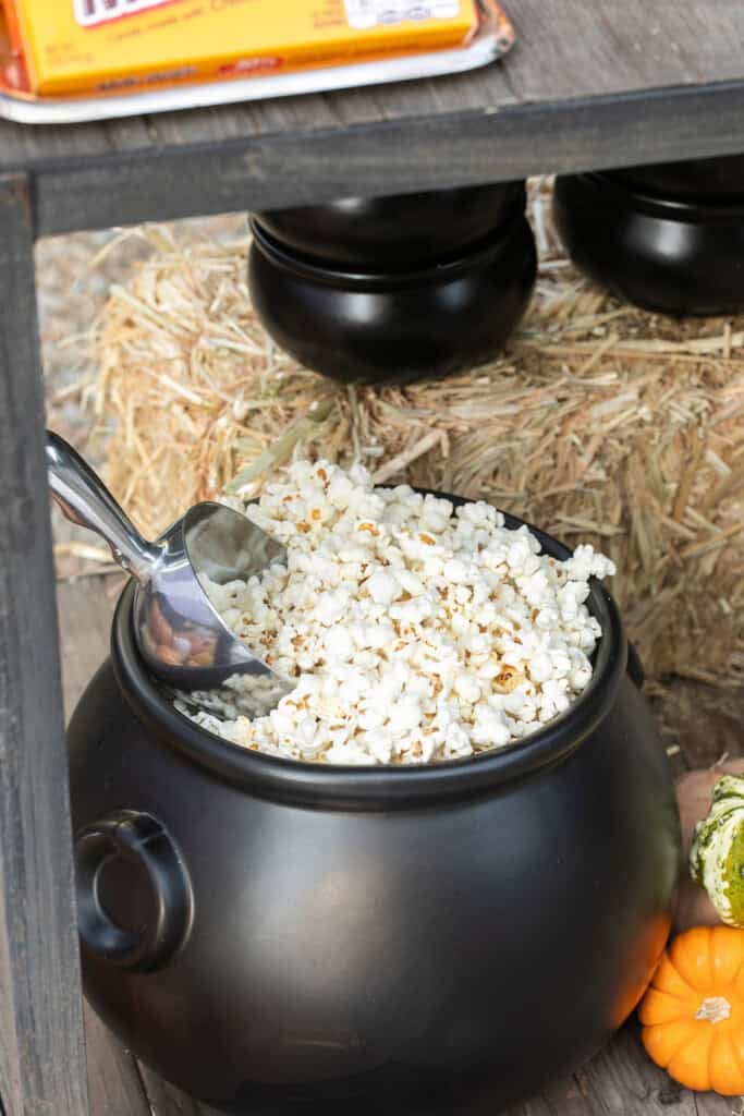 Fresh popcorn in a black cauldron. 