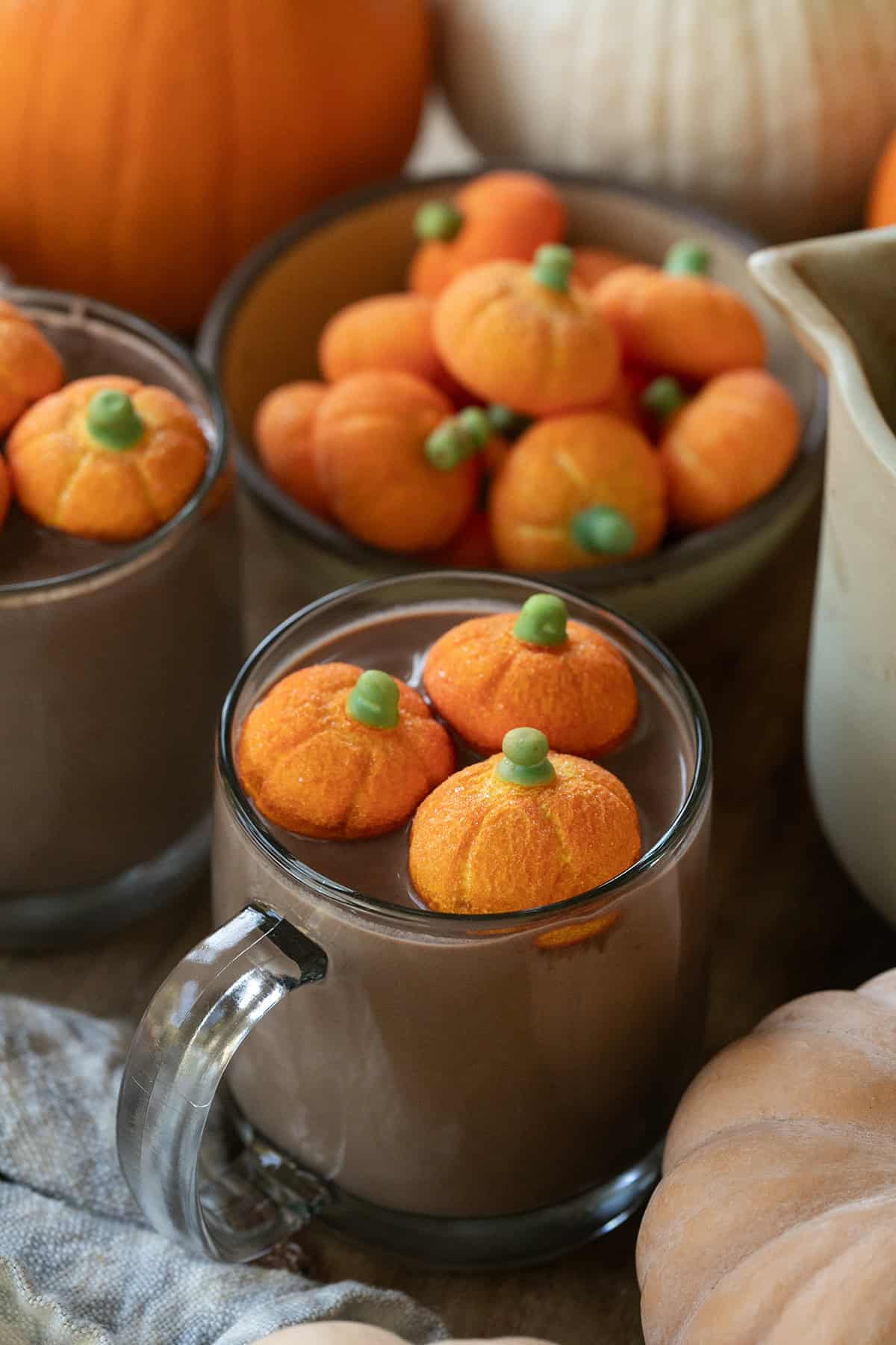 Pumpkin hot chocolate in a mug with pumpkin marshmallows.