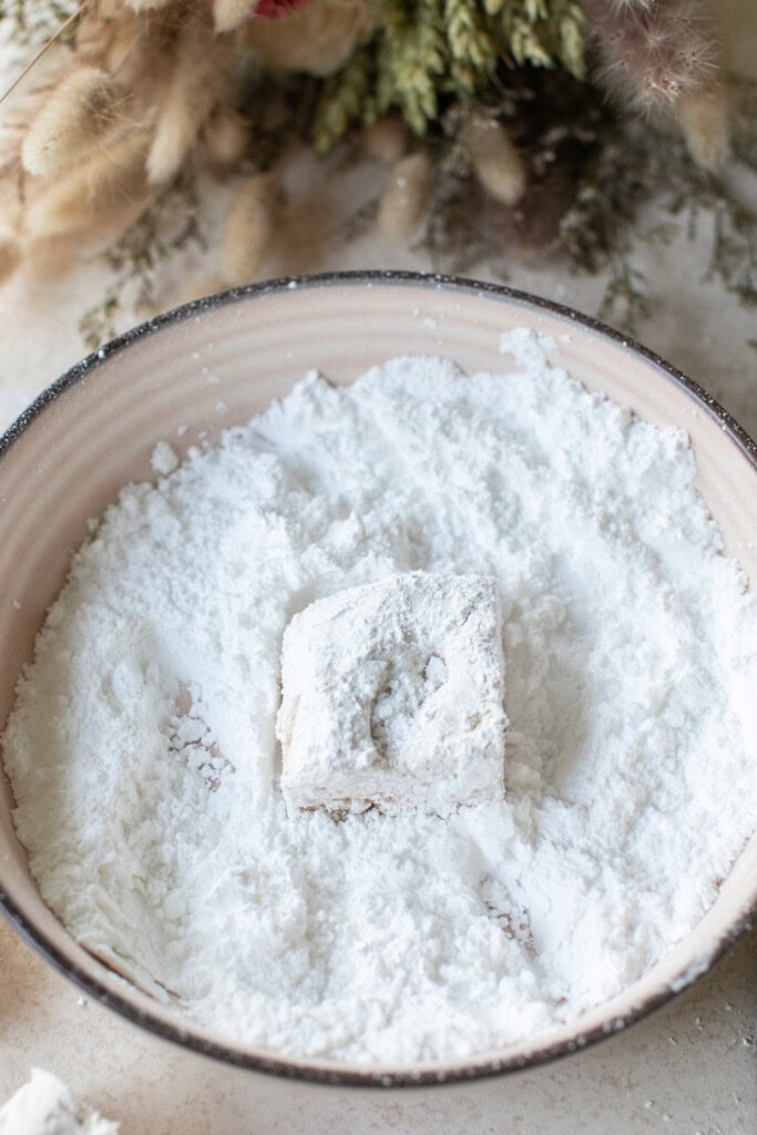 Maple syrup marshmallows in a dusting of powdered sugar.
