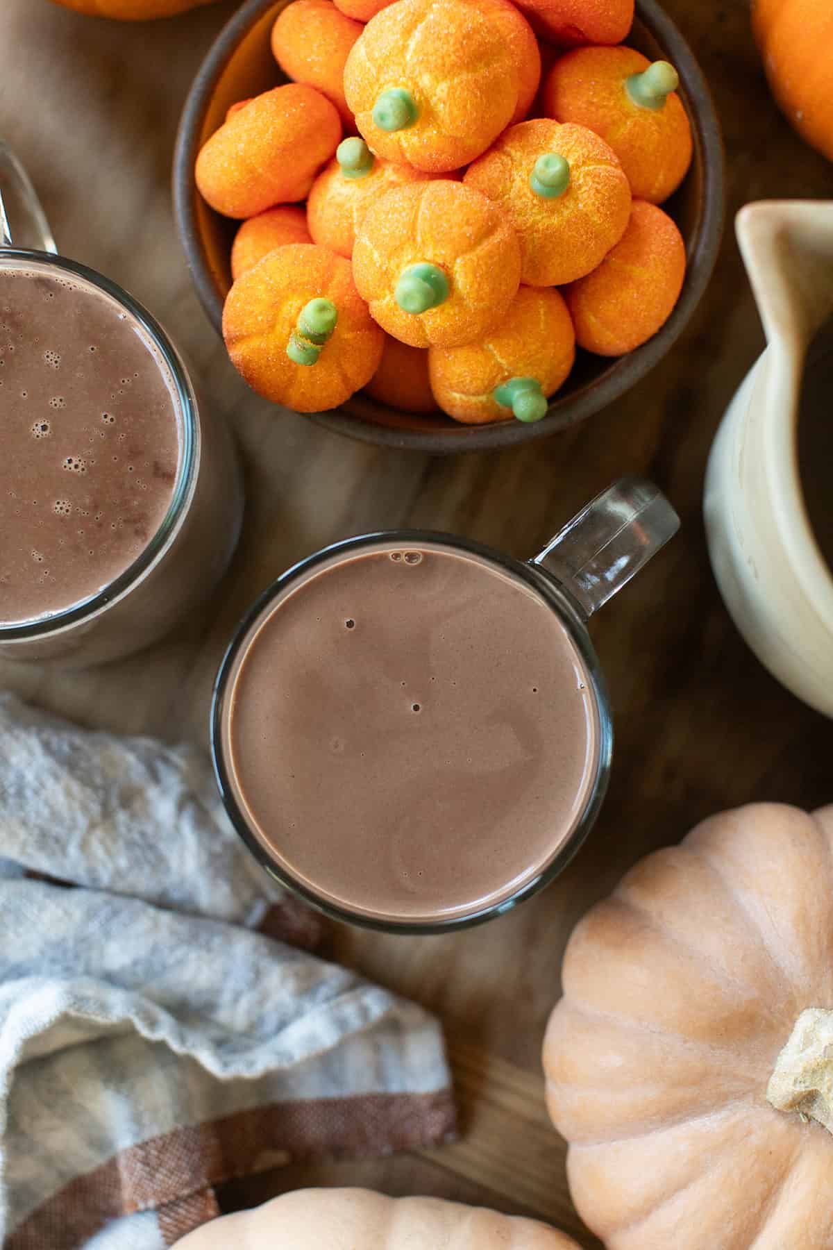 Fall drink station with pumpkin hot chocolate and autumn decorations.