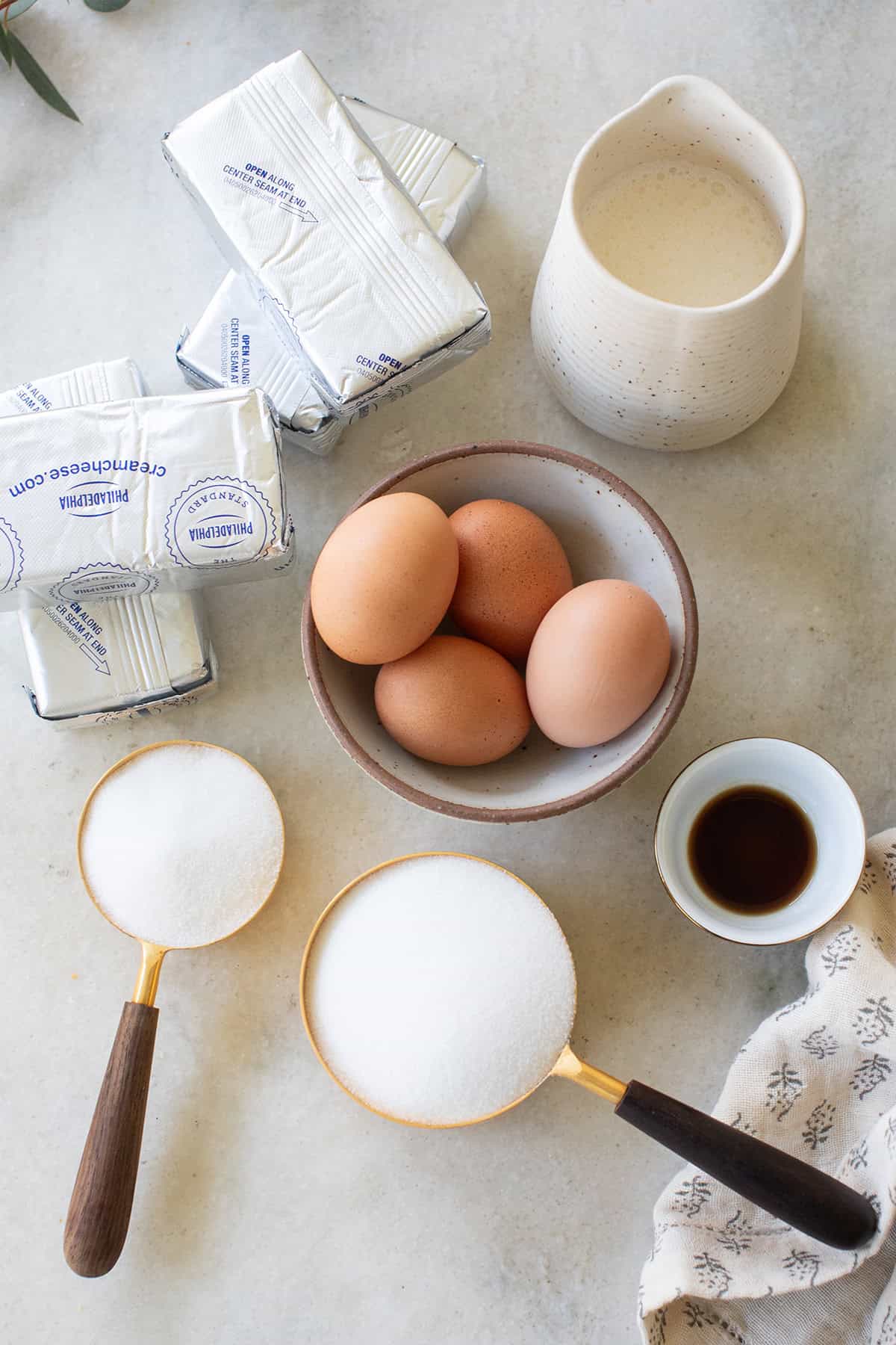 ingredients on a table to make a Bailey's Irish Cream cheesecake recipe.