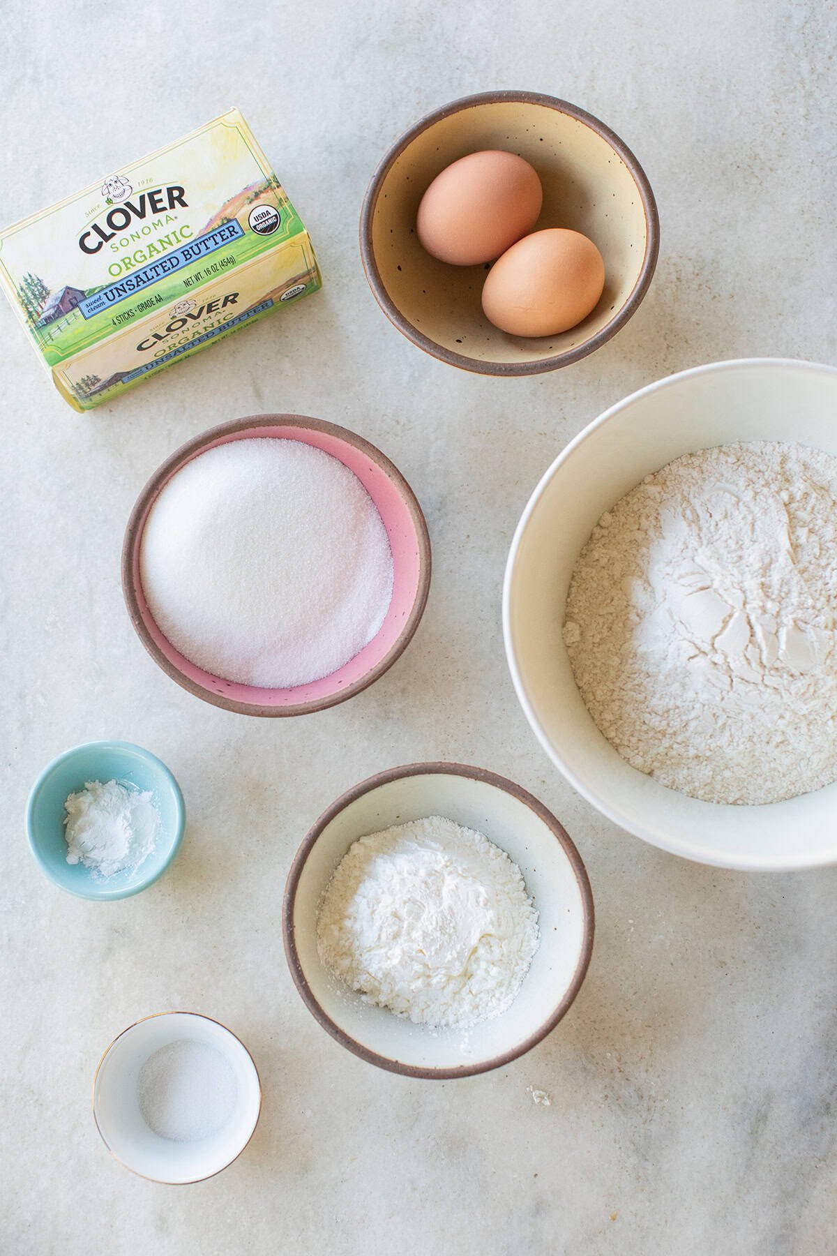Ingredients to make cut out sugar cookies on a table.