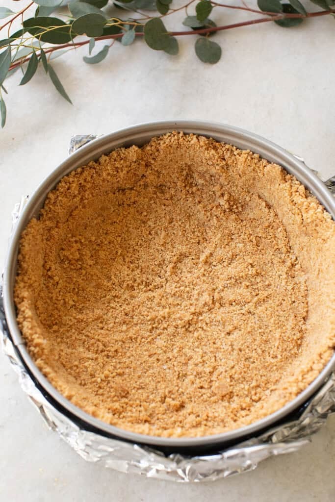 Graham cracker crust in a springform pan ready for cheesecake filling.
