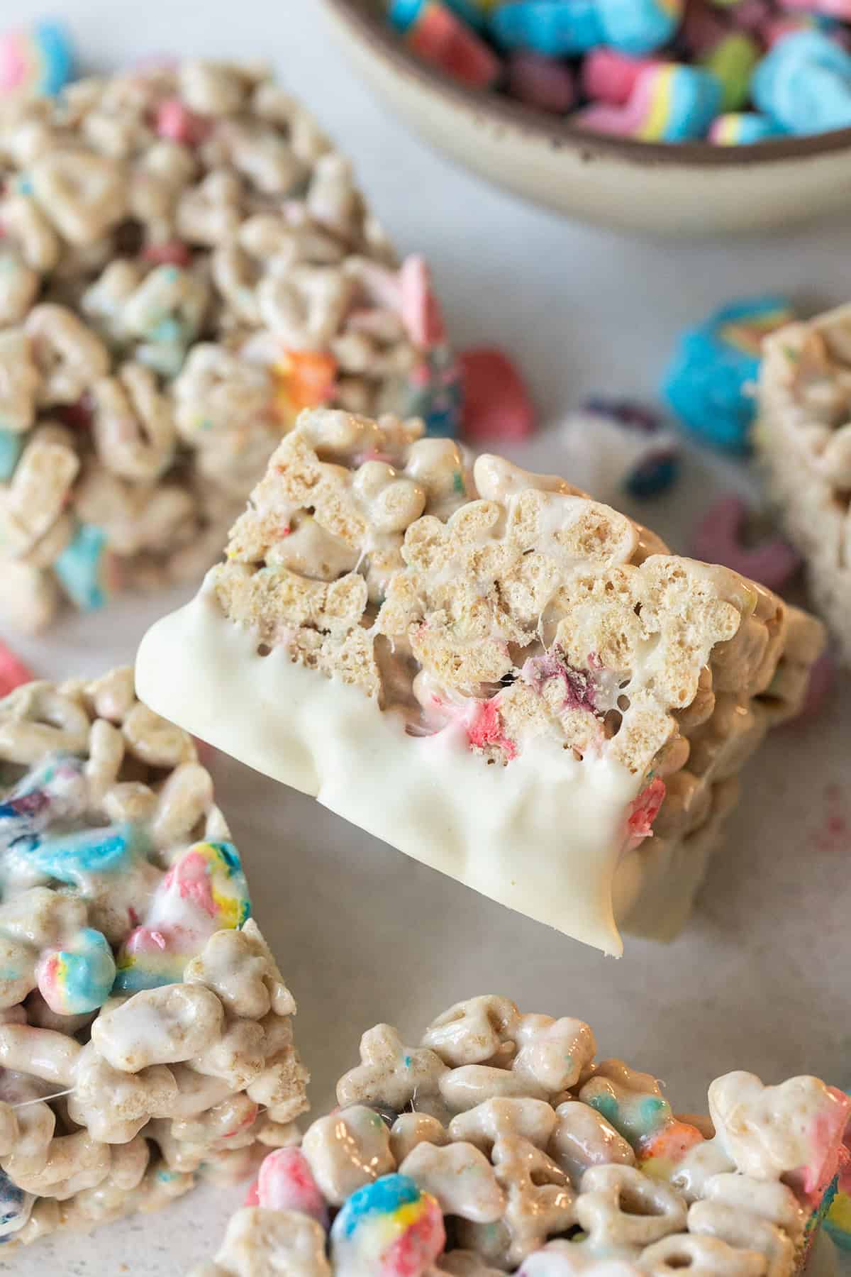 Vibrant rice krispies treats topped with colorful sprinkles and drizzled with white chocolate, perfect for celebrations.