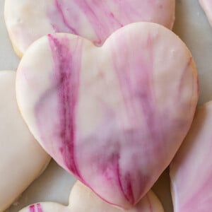 Heart shaped sugar cookie with marble swirl icing.