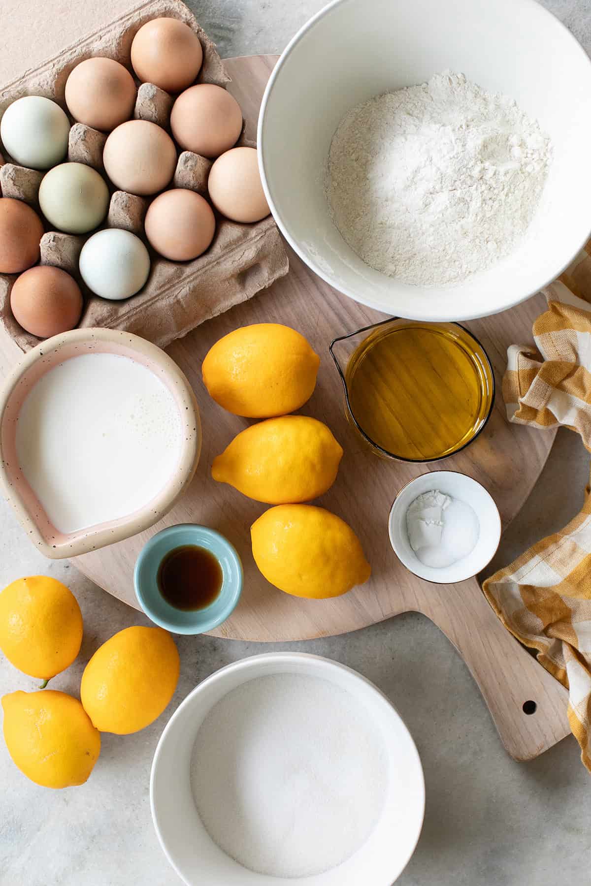 Ingredients to make a lemon olive oil cake: Olive oil, whole milk, eggs, flour, lemon juice and lemon zest.
