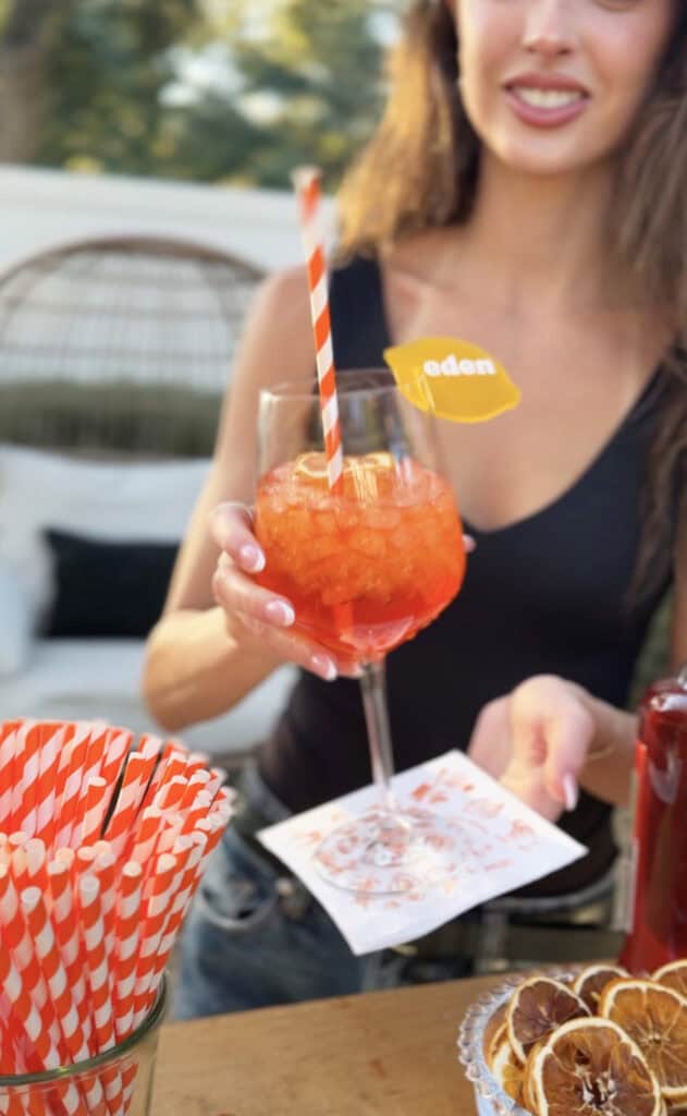 Aperol spritz served in a glass with an orange slice garnish.