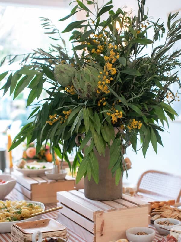 Italian Aperitivo Party flowers on a table filled with appetizers.