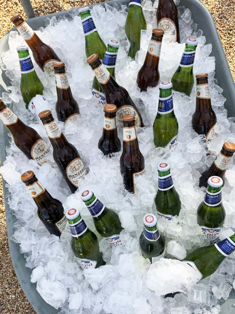 Italian beer served in a wheelbarrow filled with ice for outdoor party.