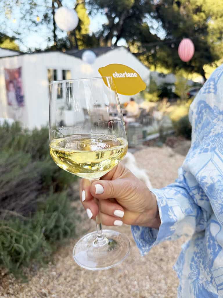 Glass of Italian white wine with a lemon drink tag.