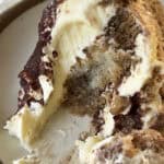 Slice of easy no bake tiramisu showing espresso soaked ladyfingers and creamy mascarpone layers.