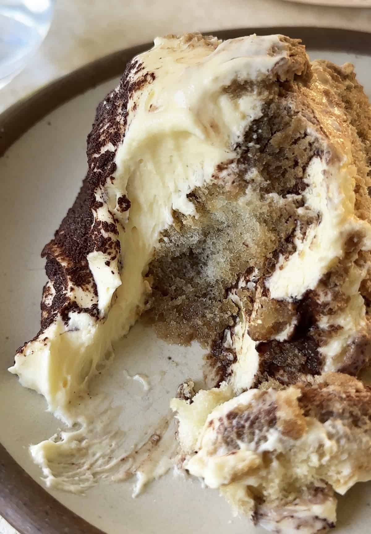 Slice of easy no bake tiramisu showing espresso soaked ladyfingers and creamy mascarpone layers.