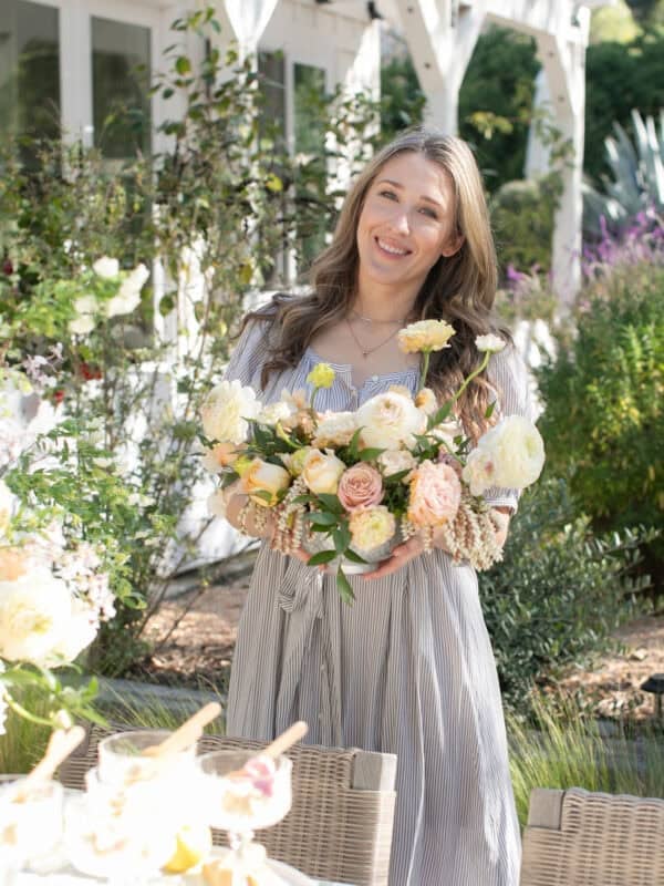 Eden Passante holding flowers at her garden party.