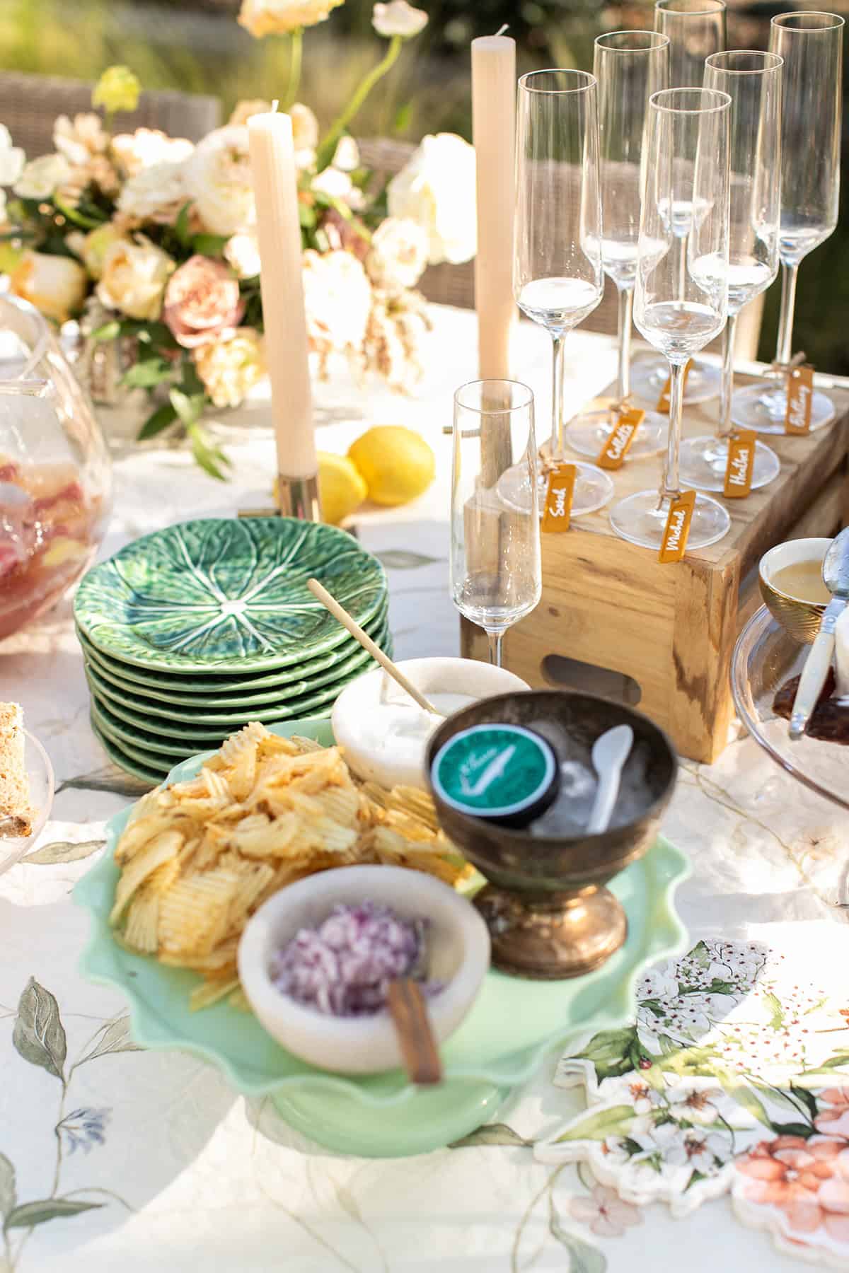 Caviar on a platter with candles and flowers for a Champagne party.
