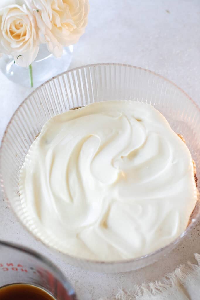 Mascarpone filling in a trifle dish for tiramisu.