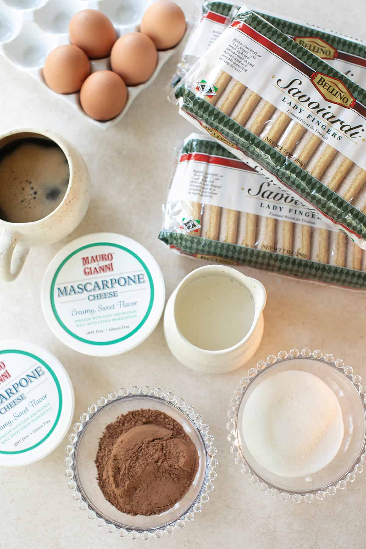 Ingredients for an easy tiramisu recipe, including mascarpone cheese, espresso, ladyfingers, and pasteurized eggs.