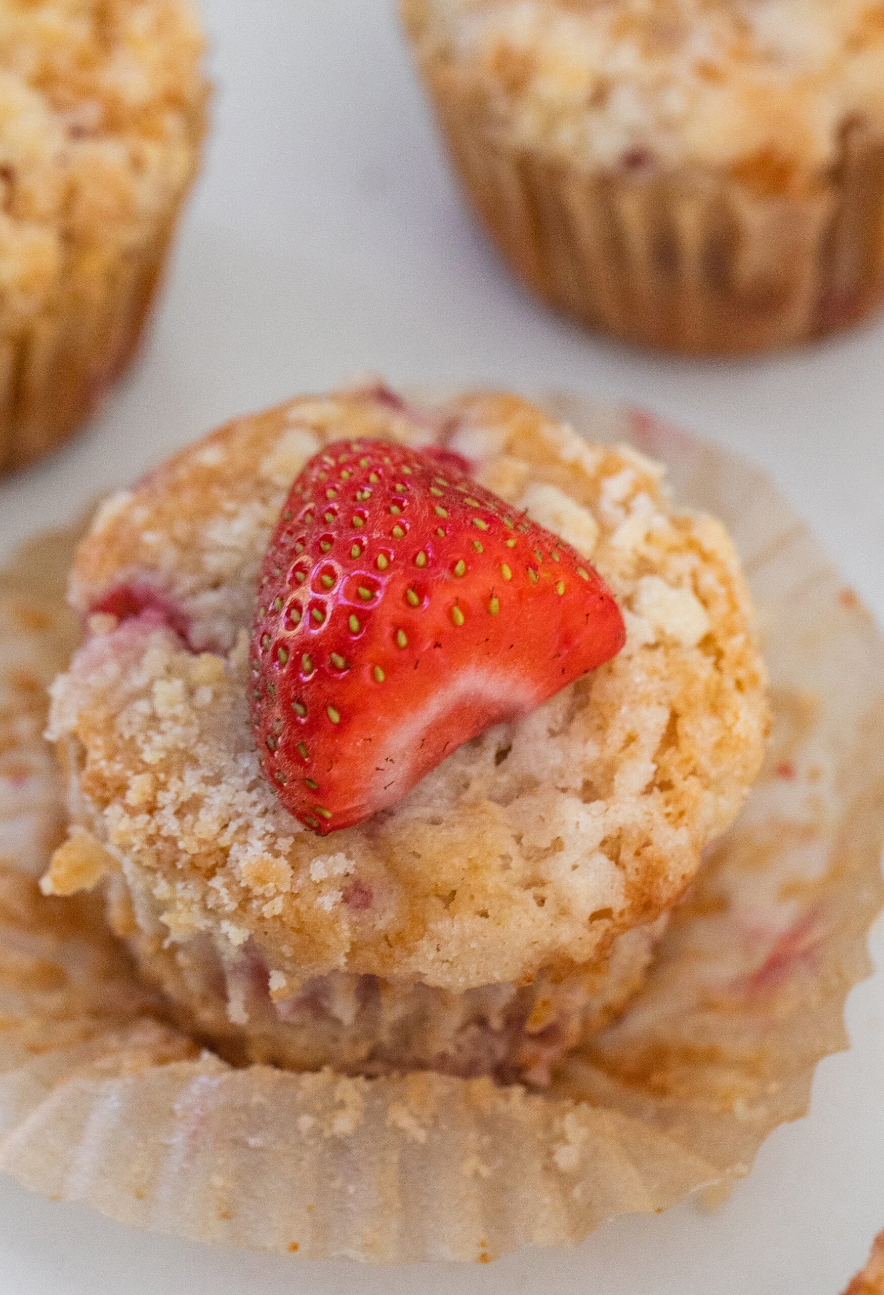 Moist strawberry muffins with fresh strawberries.