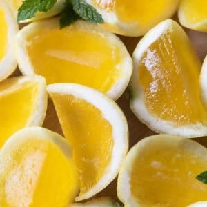 Easy Hugo spritz jello shots recipe with elderflower liqueur and Prosecco served in citrus cups.