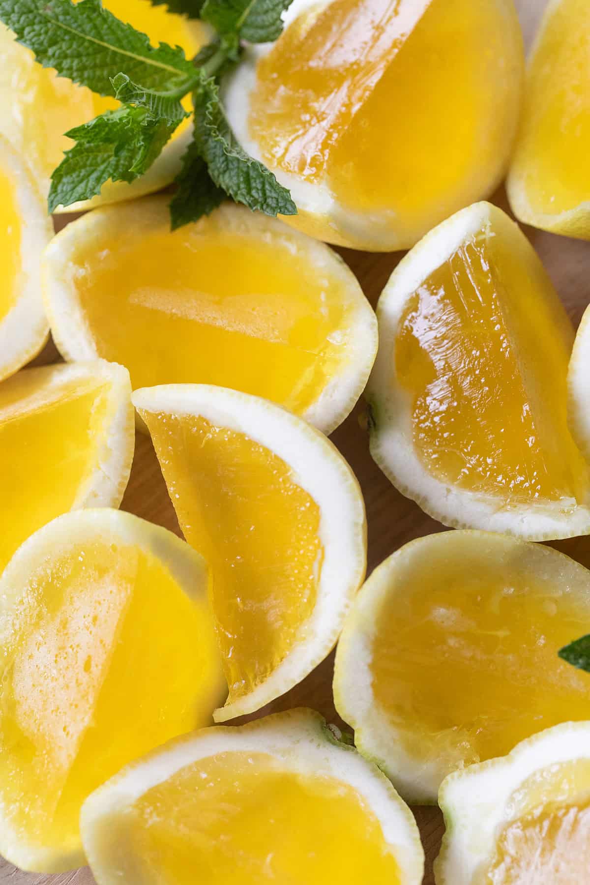 Easy Hugo spritz jello shots recipe with elderflower liqueur and Prosecco served in citrus cups.