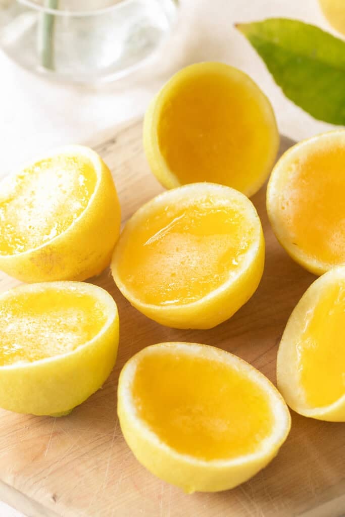 Hugo spritz Jello shots in citrus lemon cups.