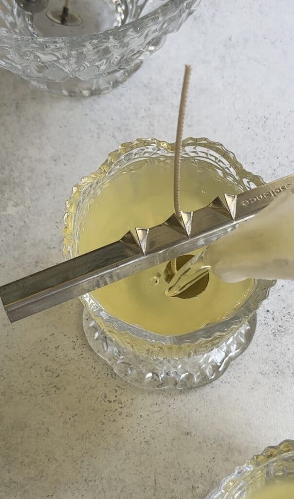 Pouring melted wax into a vintage glass candy dish.