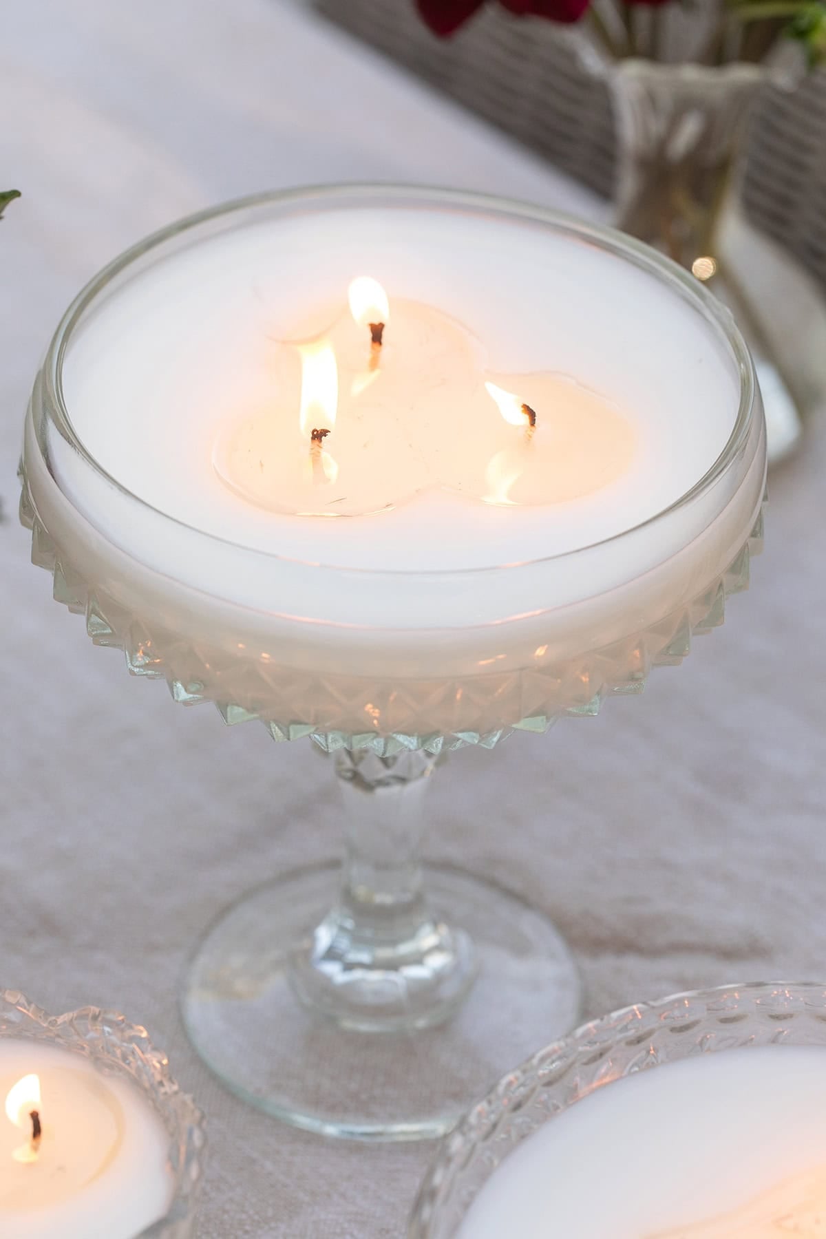 Vintage lidded glass candle styled on an outdoor table.