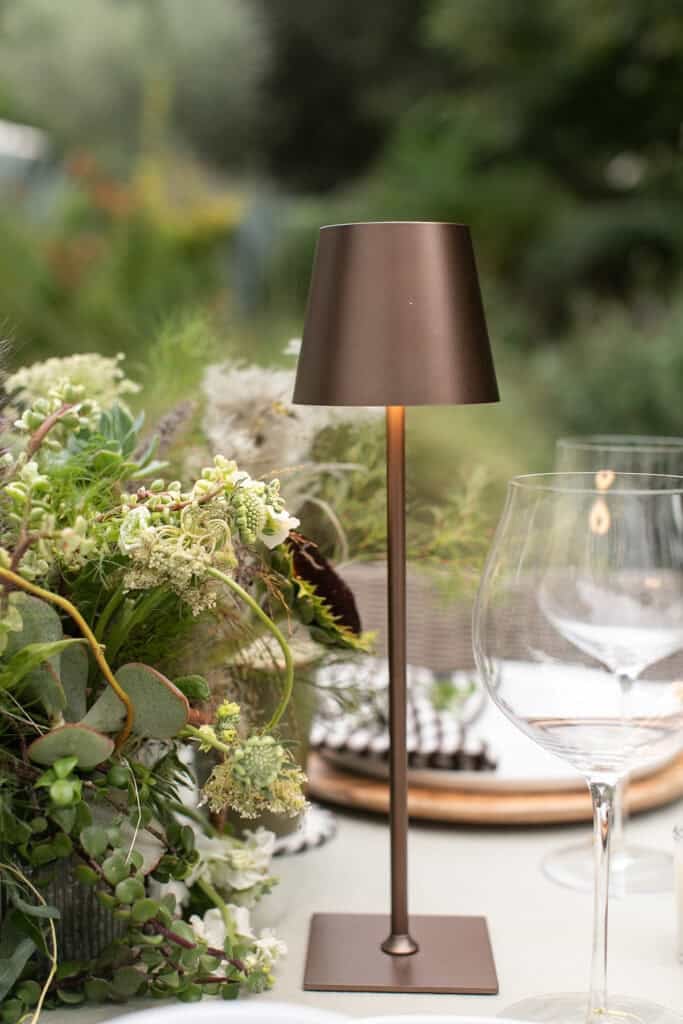 Outdoor, cordless table lanterns on a rodeo dinner party table setting.