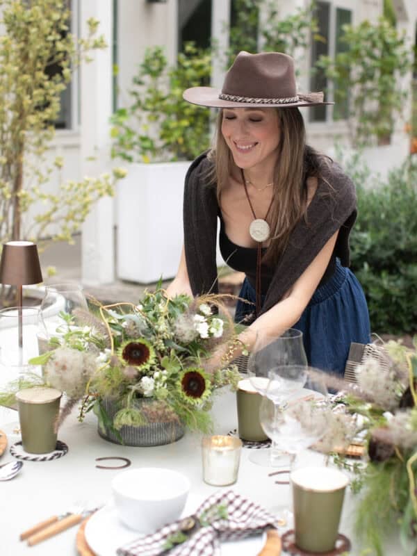 Eden Passante setting flowers down at her rodeo themed dinner party.